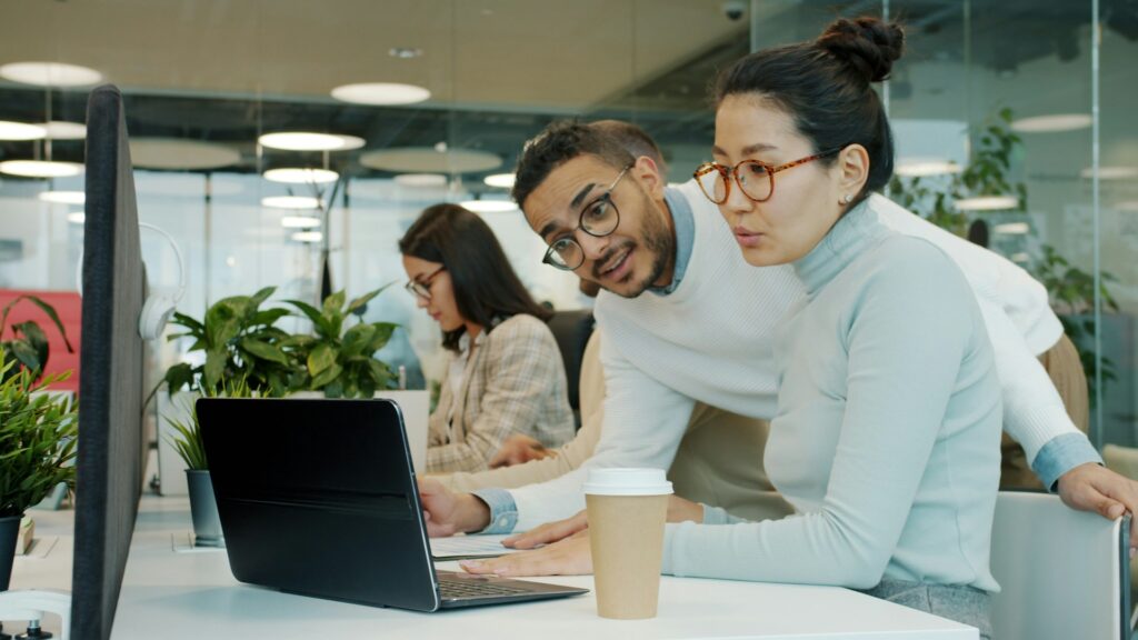 coworkers looking at computer screen